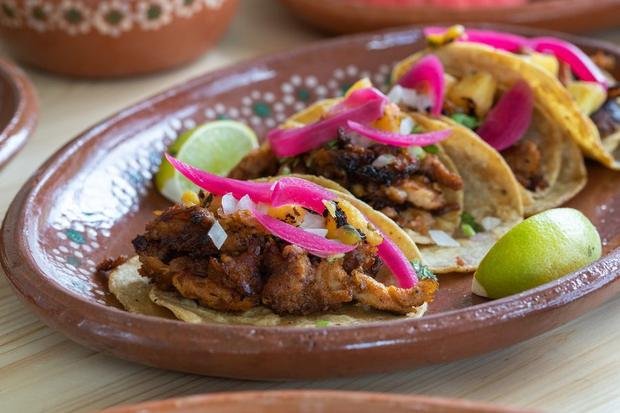 Tacos al pastor on a painted clay plate
